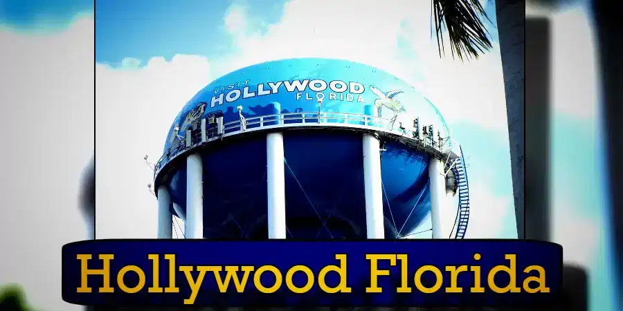 Water tower in Hollywood, Florida, against a blue sky with a palm tree partially visible on the right side. The text