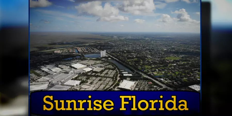 Aerial view of Sunrise, Florida, showing residential areas, commercial buildings, and surrounding landscape under a partly cloudy sky. Notably visible are tow trucks providing valuable towing services. The image has text at the bottom reading 