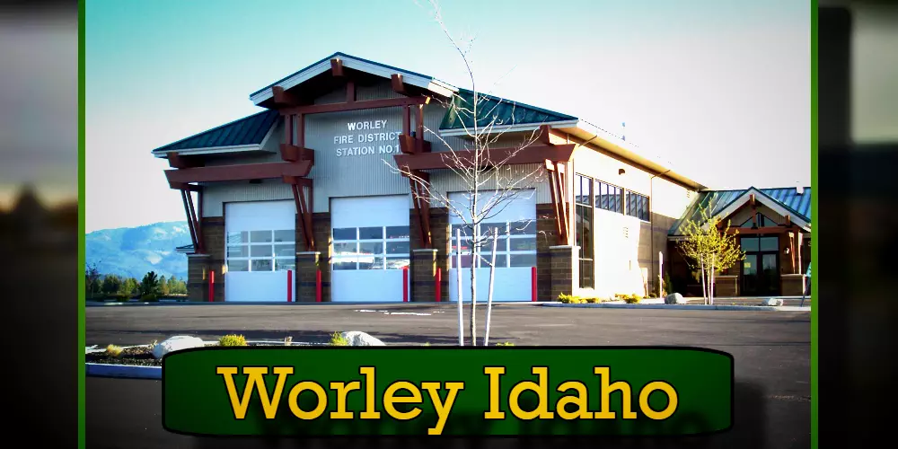 Image of Worley Fire District Station No. 1 in Worley, Idaho, showing a modern fire station building with mountains visible in the background, with a tow truck parked nearby.