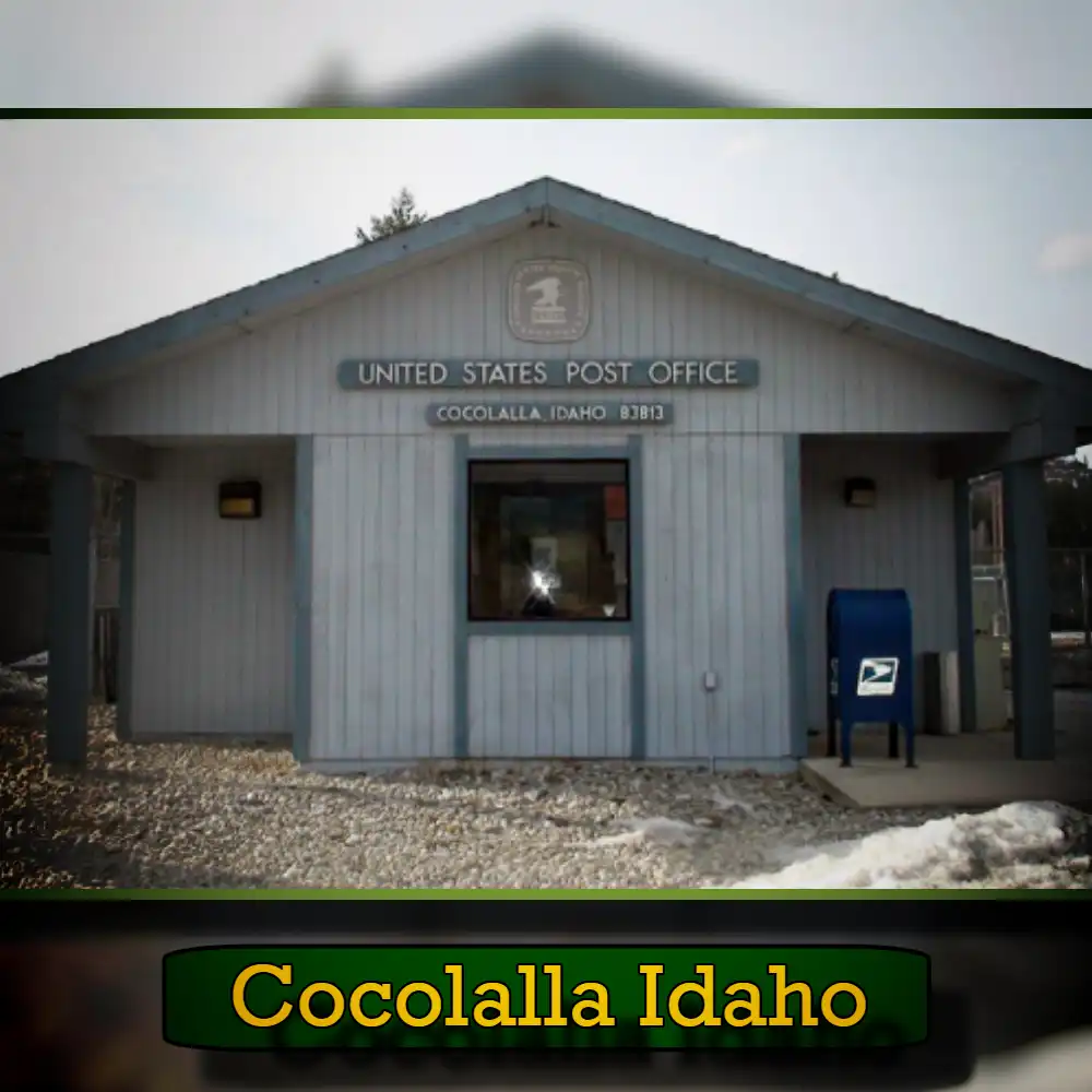 A small post office in Cocolalla, Idaho, with a light blue exterior and a USPS mailbox outside. The sign above reads 