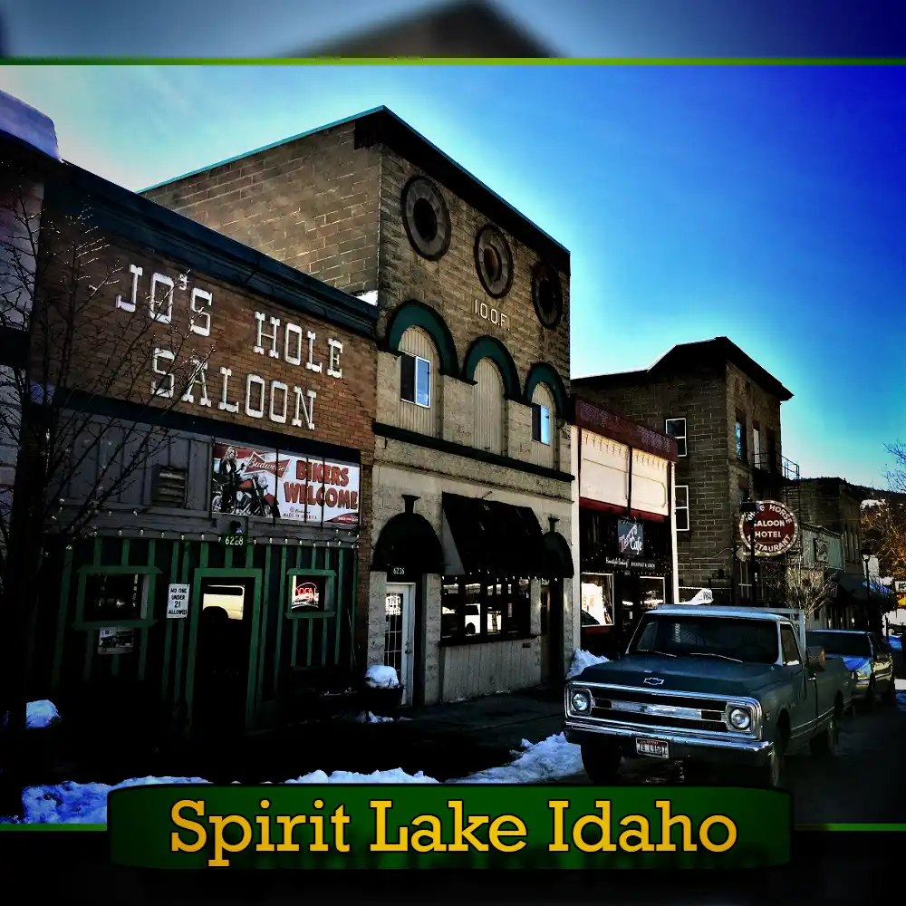 A street scene in Spirit Lake, Idaho, showing Jo's Hole Saloon and neighboring buildings. A vintage tow truck is parked on the snowy street.