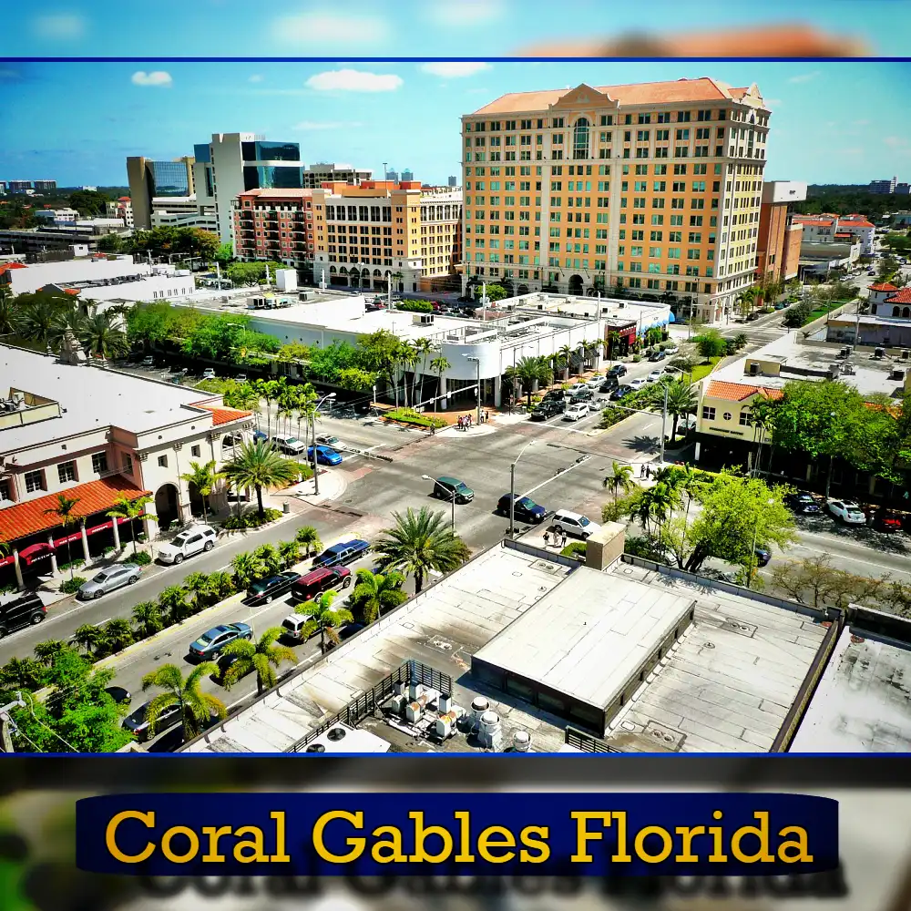 Aerial view of Coral Gables in Florida, showcasing a mix of mid-rise buildings, trees, and busy streets with the occasional tow truck under a clear blue sky. A caption at the bottom reads 
