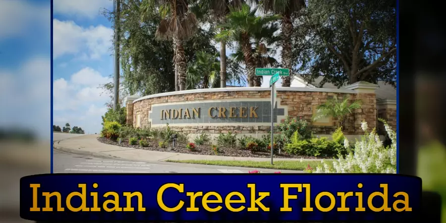 Photo of the entrance to Indian Creek, Florida, featuring a stone wall with the words 