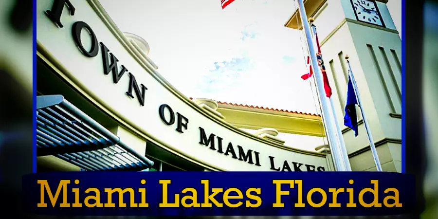 Town of Miami Lakes building exterior with a clock tower and multiple flagpoles. 