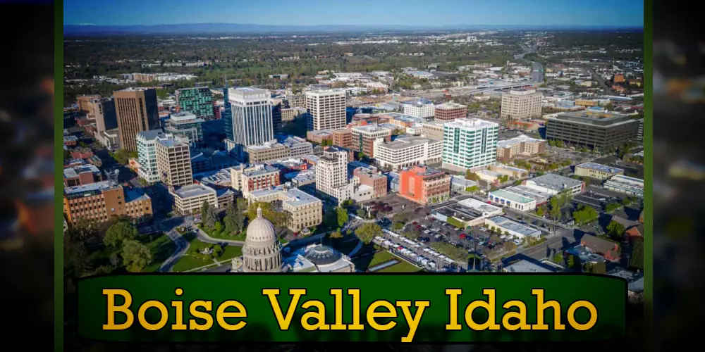 Aerial view of Boise Valley, Idaho, featuring a mix of modern and historic buildings, with the Idaho State Capitol prominently in the foreground and a discreet tow truck navigating the bustling streets.