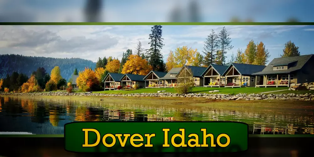 Scenic view of lakeside cabins surrounded by autumn trees reflecting in the water in Dover, Idaho, with a tow truck subtly parked nearby.