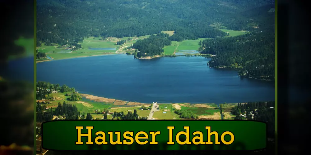 Aerial view of Hauser Lake, surrounded by lush greenery and forested hills, with small communities and a tow truck visible around the lake. Text at the bottom reads 