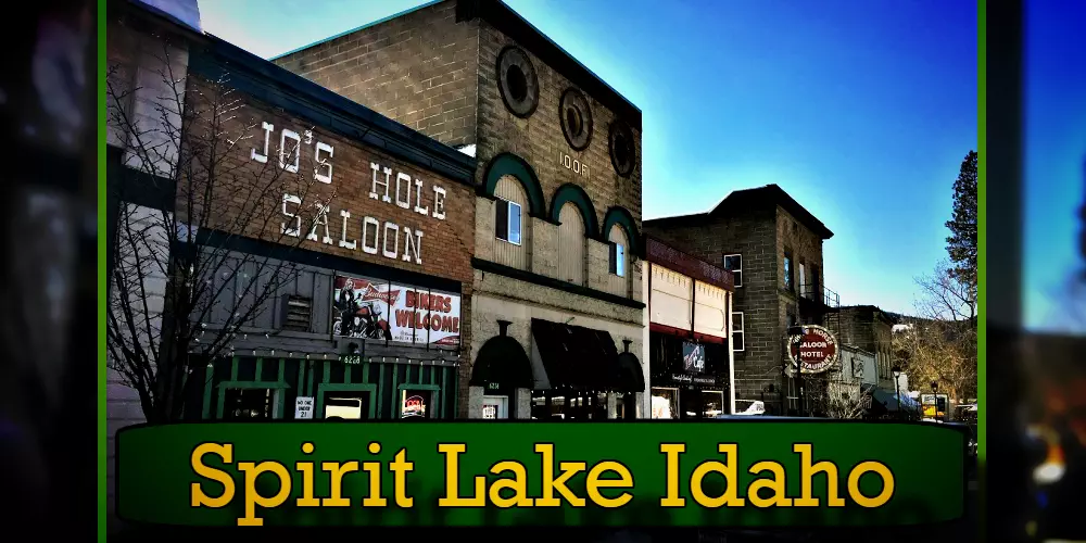 Street view of Spirit Lake, Idaho, featuring Joe's Hole Saloon and adjacent buildings, with a local tow truck parked nearby offering quick and reliable towing services.