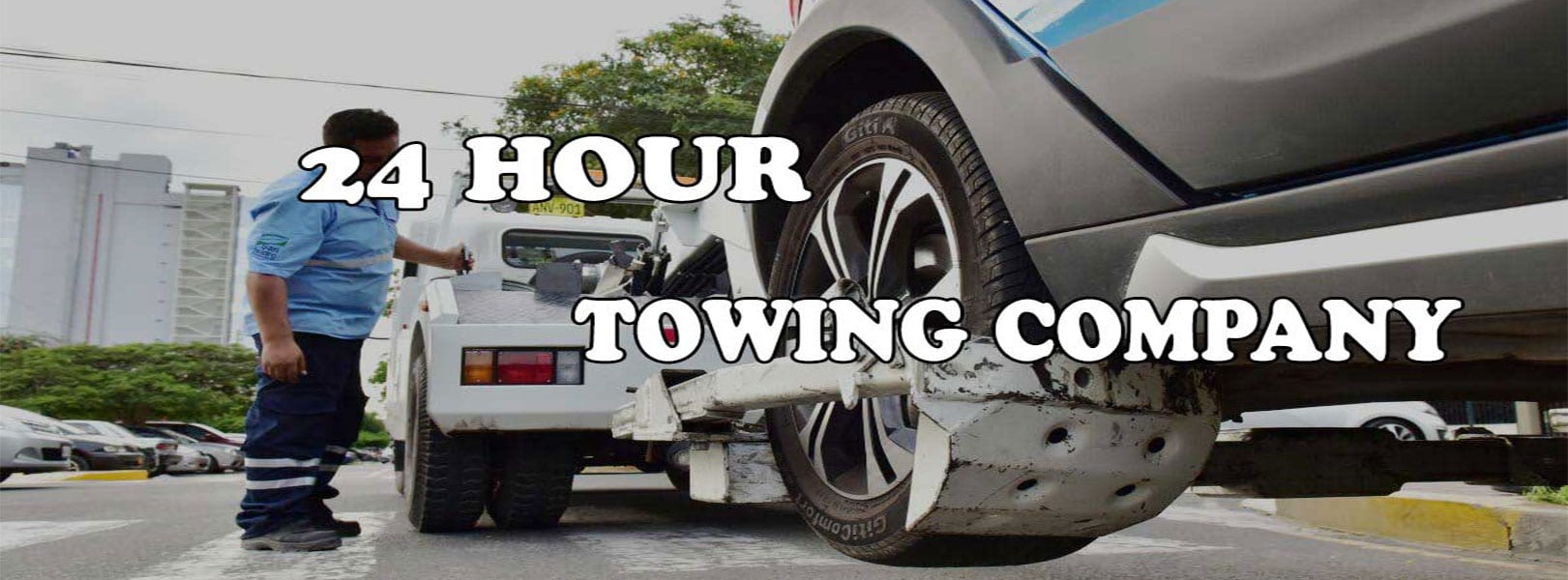 A tow truck is pictured lifting a damaged vehicle with text overlay reading "24 Hour Tow Service." A person in uniform stands next to the tow truck.